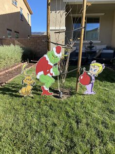 two cartoon figures are in the grass near a tree and fence with a house in the background