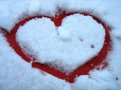 a heart - shaped object is covered in snow