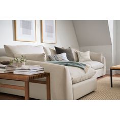 a living room filled with furniture and a coffee table in front of a white couch