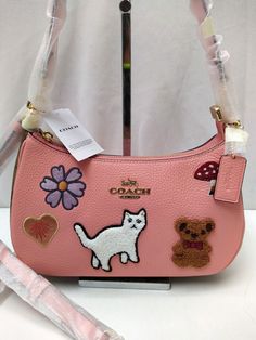 Coach Teri Candy Pink Leather with Creature Patches Crossbody Shoulder Bag 100% authentic New with tag MSRP: $425   Features: Refined pebble leather and Signature coated canvas Two credit card slots Inside multifunction pocket Zip-top closure, fabric lining Detachable handle with 8 1/4" drop Detachable strap with 22 3/4" drop for shoulder or crossbody wear 9 1/2" (L) x 6" (H) x 3" (W) Style No. CC420 Please see the images for further detail and ask any questions you may have before making a bid. Trendy Coach Shoulder Bag With Double Handle, Trendy Coach Bag With Detachable Handle, Designer Coach Shoulder Bag For Errands, Coach Designer Crossbody Shoulder Bag, Designer Coach Crossbody Shoulder Bag, Coach Leather Crossbody Shoulder Bag, Designer Coach Shoulder Bag, Pink Coach Leather Shoulder Bag, Trendy Coach Crossbody Bag