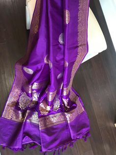 This is a beautiful handloom katan silk light weight banarasi in deep purple/ egg plant shade with beautiful sona rupa bird motifs in body and floral and bird motifs in gold zari in pallu, all in kadua weave. Saree comes with a stitched blouse in standard size 36-38. Saree is finished with tassels and falls and pico are done.  *colour may vary slightly due to lighting and individual device settings. *Falls and Pico- Yes * Tassels-Yes *Blouse-yes, standard size 36 with margin for size 38 * All sa Purple Banarasi Silk Saree With Self Design, Traditional Purple Jamawar Wear, Purple Traditional Wear With Pallu For Diwali, Purple Jamawar Traditional Wear For Diwali, Elegant Purple Jamawar Dupatta, Purple Jamawar Dupatta With Zari Work, Purple Banarasi Silk Traditional Wear With Pallu, Purple Tussar Silk Traditional Wear With Pallu, Purple Katan Silk Saree With Self Design