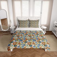 a bedroom with a bed, nightstands and mirror in front of the window is shown