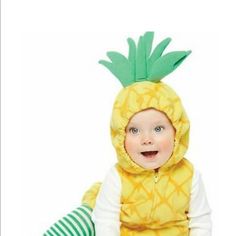 a baby wearing a yellow pineapple costume