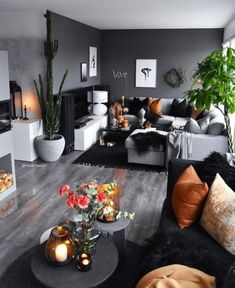 a living room filled with lots of furniture and plants on top of the couches