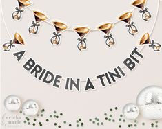 a party banner that says a bride in a tint bit with bells and bows