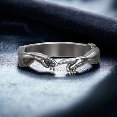 Embrace the profound symbolism of faith with this Book of Genesis Creation of Adam Adjustable Ring, exquisitely crafted from 925 sterling silver. This unique ring features a detailed depiction inspired by Michelangelo's iconic Creation of Adam, symbolizing the divine connection between God and humanity. Designed for both men and women, this spiritual statement piece adds a touch of biblical elegance and reverence to any outfit. The adjustable band ensures a comfortable fit, making it a versatile Symbolic Promise Jewelry With Polished Finish, Adjustable Symbolic Jewelry With Engraving Option, Spiritual Sterling Silver Rings With Engraving Option, Symbolic Sterling Silver Promise Jewelry, Sterling Silver Open Ring With Engraving Option, Symbolic Promise Rings With Polished Finish, Adjustable Silver Rings With Engraving Option, Nickel Free Silver Engraved Ring For Promise, Symbolic White Gold Jewelry For Promise