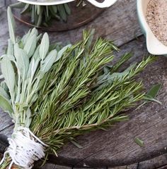 some herbs are sitting on a wooden table