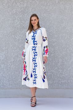 **Note : The kaftan in the video is a different color of the exact same Kaftan and is only displayed to show the fit, flow, and cut of the Kaftan. You will receive the one in the pictures.** Feel like a bohemian queen in this eccentric and beautiful embroidered tunic dress. The dress is made of Linen and Egyptian cotton which is widely renowned for its quality and texture. The dress is light and extremely soft and can be used on many occasions - beach, lounge, or even in your home to feel comfor Peasant Style Dress With Multicolor Embroidery, Peasant Dress With Multicolor Embroidery, Folk Tunic Dress With Multicolor Embroidery, Long Peasant Spring Dress, Spring Peasant Long Dress, Spring Long Peasant Dress, Spring Embroidered Relaxed Fit Dress, Spring Folk Style Kaftan With Geometric Embroidery, Traditional Long Sleeve Midi Dress For Summer