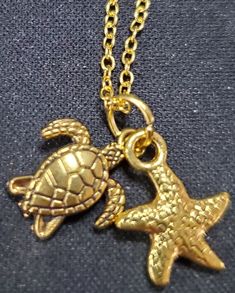 20 inch gold plated chain with gold turtle and sea star charms Ocean-inspired Gold Jewelry With Starfish Charm, Gold Metal Jewelry With Starfish Charm, Handmade Gold Ocean-inspired Charm Necklaces, Gold Jewelry With Starfish Charm, Gold Jewelry With Starfish Charm As A Gift, Gold Jewelry With Starfish Charm For Gift, Handmade Ocean-inspired Gold Charm Necklaces, Adjustable Gold Ocean-inspired Charm Necklace, Gold Starfish Charm Jewelry