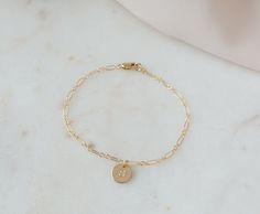 These initial bracelet are a timeless, classic and elegant gift that will always be in style. The perfect birthday gift, for Mom, Grandma or anyone special in your life.  If you're looking to get something special for someone who likes to keep it classy, this bracelet makes a great choice.   ⭐︎ Details:      ♡ 14k Gold Filled Chain High Quality (Tarnish Resistant)      ♡ 100% hypoallergenic, lead and nickel free.     ♡ Waterproof Quality    C A R E ∙ T I P S To maintain the Perfect Quality of your new Velvet Collection Necklace, please: * Wash your bracelet with neutral soap once a week. Don't forget to dry it perfectly! * Gently polish with a soft, lint-free cloth.  * Avoid direct contact with perfumes, body oils, and other chemicals, including household cleaners.  * Store your beloved je Alphabet Bracelet, Gift Letter, Initial Bracelet Gold, Disc Bracelet, Birthday Gift For Mom, Letter Bracelet, Letter Gifts, Velvet Collection, Body Oils