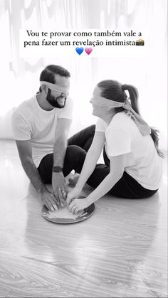 a man and woman sitting on the floor together