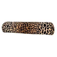 an animal print roll pillow on a white background with the word's name printed in black