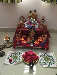 there is a small shrine with flowers on the table and other decorations in front of it