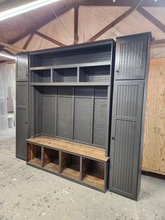 an empty storage room with wooden shelves and benches