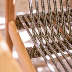 the back end of a chair with rope on it