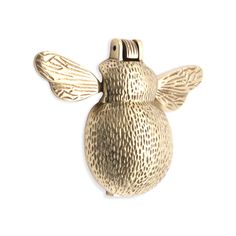 a gold bee shaped object on a white background