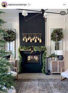 a living room decorated for christmas with wreaths and garland on the fireplace mantel