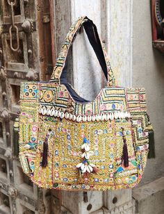 About bag  Indo-gypsy fusion, everyday use hand bag made from Banjara fabrics sourced from Vintage tribal costumes of regions of Rajastan and Gujarat. These are embellished with light catching coins, and intricate bead work tassels. Company details:  Company name: Houseoftextile  Contact number: +919784447473  Email id: houseoftextile77@gmail.com  Shipping & custom : Delivery through one of the finest service providers : Skyway, Fedex, UPS  And DHL. Any local taxes\custom has to be paid by clien Bohemian Rectangular Potli Bag For Festive Season, Bohemian Embellished Bag For Festive Occasions, Multicolor Embellished Shoulder Bag For Festivals, Festive Bohemian Rectangular Potli Bag, Vintage Bags For Festive Occasions, Traditional Embellished Multicolor Bags, Bohemian Embellished Shoulder Bag For Festive Occasions, Traditional Embellished Multicolor Shoulder Bag, Traditional Multicolor Embellished Shoulder Bag