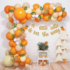 an orange themed party with balloons and decorations