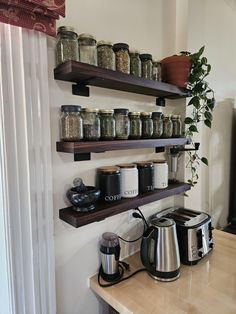 the shelves are filled with spices and coffee pots, along with other kitchen items on them