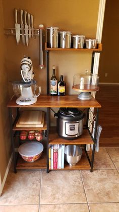 a kitchen area with shelves, pots and pans