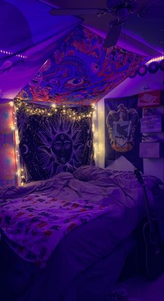 a bedroom with purple lights and a bed covered in blankets