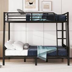 a black bunk bed sitting next to a white wall