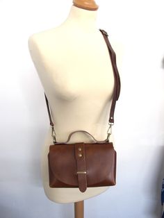 Handmade shoulder leather bag with a classy shape. It can be worn cross-body too and despite its small shape can easily hold your daily essentials. Also, it's a perfect choice for a night out, just remove the shoulder strap and carry it with the featuring top handle. It comes without lining in 6 colors brown, black, goldish black, bordeaux, light gray and ivory. The hardware is available in silver, gold and bronze. WIDTH: 20cm/7.9 inches, LENGTH: 12cm/4.7inches DEPTH: 8cm/3.1inches ADJUSTABLE ST Everyday Crossbody Flap Bag, Classic Crossbody Shoulder Bag For Everyday, Everyday Brown Crossbody Flap Bag, Brown Everyday Crossbody Flap Bag, Leather Lining Crossbody Satchel, Crossbody Satchel With Leather Lining For On-the-go, Leather Flap Clutch Bag, Leather-lined Crossbody Satchel For On-the-go, Everyday Use Crossbody Shoulder Bag With Leather Lining