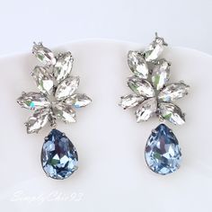 "Elegant Vintage style Bridal Earrings. Made with high-quality Crystal rhinestones in light blue and clear crystals. Gorgeous and elegant floral-inspired drops. Pair them with a cocktail dress or an over-sized sweater for an everyday look. Rhodium silver plated 2\" length, 1\" width Glass crystals Surgical steel posts, hypoallergenic" Blue Earrings Aesthetic, Goth Corsets, Earrings Weddings, Crystals Labradorite, Royal Blue Earrings, Blue Statement Earrings, Quinceanera Jewelry, Blue Bridal Earrings, Blue Chandelier