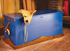 a blue box with a yellow cloth on it sitting in front of a fire place