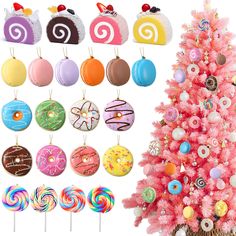 a pink christmas tree with lots of donuts hanging from it's sides and candy on the top