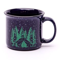 a camping mug with trees and tent on it