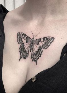 a woman with a butterfly tattoo on her chest