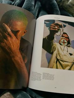 an open book with a photo of a man holding his hands up to his face