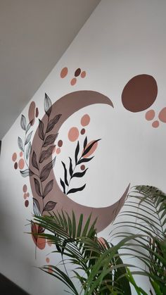 the wall is painted with different colors and designs on it, as well as plants