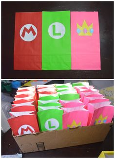 some paper bags with mario and luigi on them are sitting next to each other in a box