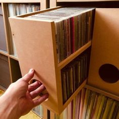 a person is opening up a record box