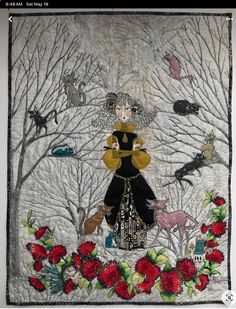 an embroidered wall hanging with a woman surrounded by animals and flowers in the background is a forest