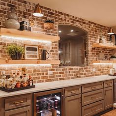 a kitchen with brick walls and built - in shelving, including a wine cooler