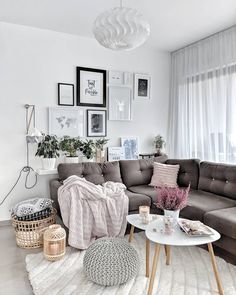 a living room filled with lots of furniture and pictures on the wall above it's coffee table