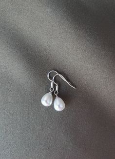 Beautiful earrings handmade with stamped 925 silver ear wires and faux teardrop-shaped pearls. Silver Drop Pearl Earrings With Pearl Drop, Silver Teardrop Jewelry With Pearl Drop, Pearl Charm Teardrop Earrings As Gift, Pearl Charm Drop Earrings As Gift, Silver Drop Pearl Earrings In Sterling Silver, Formal Teardrop Sterling Silver Pearl Earrings, Sterling Silver Drop Pearl Earrings, Silver Minimalist Pearl Drop Earrings, Silver Drop Earrings With Pearl Detail