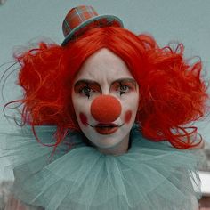 a person with red hair and clown makeup