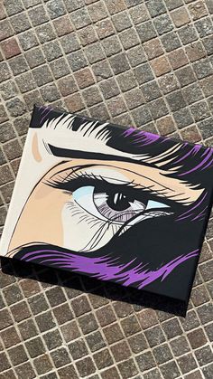 a painting of an eye on a brick wall next to a tile floor and sidewalk