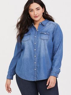 Versatile, comfortable and a closet staple, a medium wash denim shirt has a refined fit that's designed to flatter. Medium-wash denim. Spread collar. Front button closure. Button-flap chest pockets. Shirttail hem. CONTENT + CARE Cotton. Wash cold; dry low. Imported plus size tops. SIZE+ FIT Model is 5'10”, size 1. Size 2 measures 29” from shoulder. The best plus size women's medium wash denim button-up shirt chambray & shirts in dark denim made of denim. You'll want to wear these basics ever Cheap Medium Wash Denim Blouse, Cheap Relaxed Fit Chambray Shirt, Blue Jean Shirt Outfits, Jean Shirt Outfits, Capsule Basics, Chambray Shirts, Gary Clark, Jean Shirt, Fashion Nova Outfits