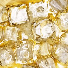 ice cubes in water with bubbles and gold flecks on the bottom, top view