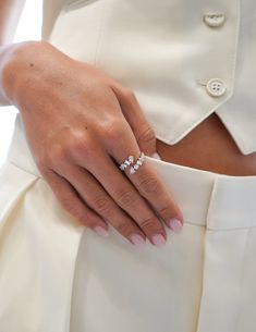 a close up of a person's hand with two rings on their fingers