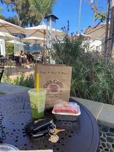 a table that has some food on top of it and a drink in front of it