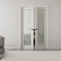 an empty white room with two chairs and a large glass door leading to another room