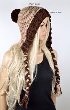 a woman with long blonde hair wearing a knitted hat