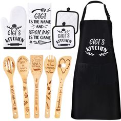 wooden utensils and bibs are on display in front of a black apron